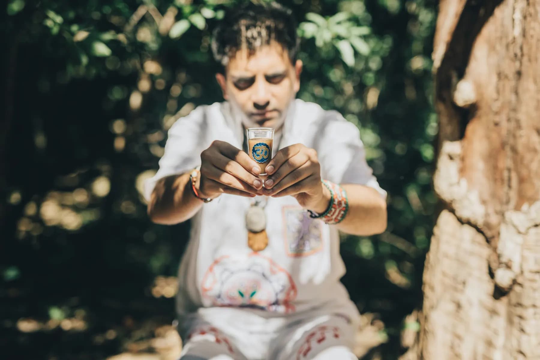 Jayesh Mitha holding a ceremonial Ayahuasca cup — preparing for ceremony