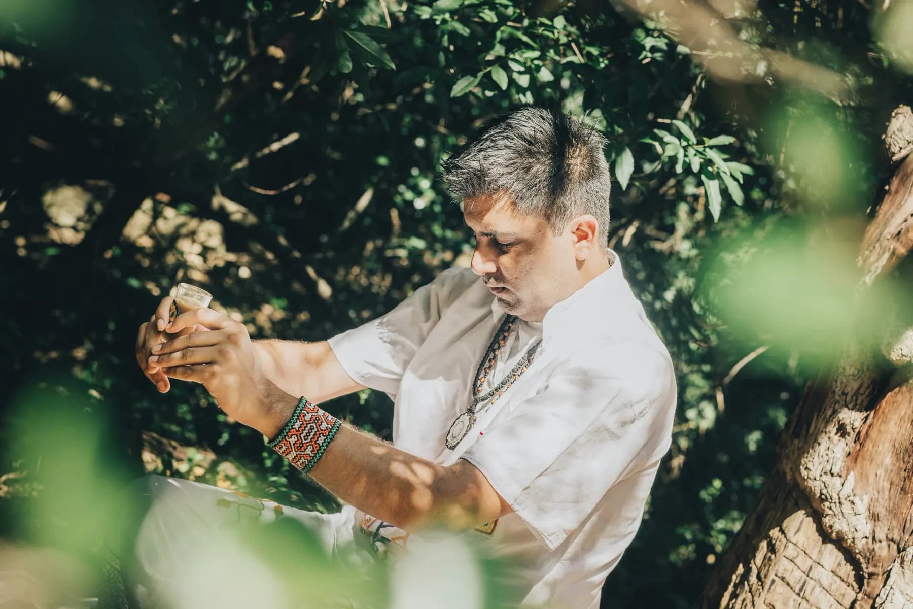 Jayesh Mitha preparing a plant medicine ceremony among the trees