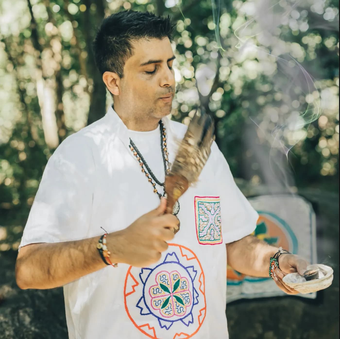 Jayesh Mitha cleansing the ceremonial space with a feather fan and sacred smoke