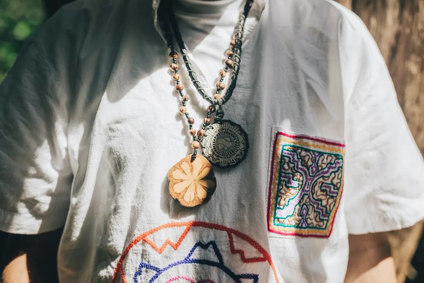 Sacred necklaces and Shipibo embroidery worn in ceremony